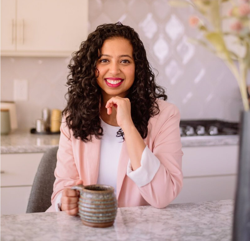 Preethi in kitchen with cup of warm tea.