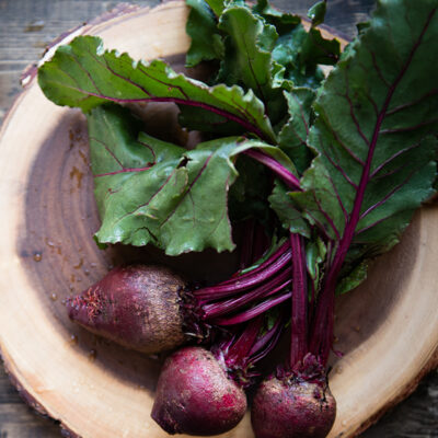 Beet greens on wood table ready to cook.
