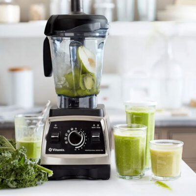 Vitamix Pro 750 Blender with green smoothie ingredients in white kitchen.