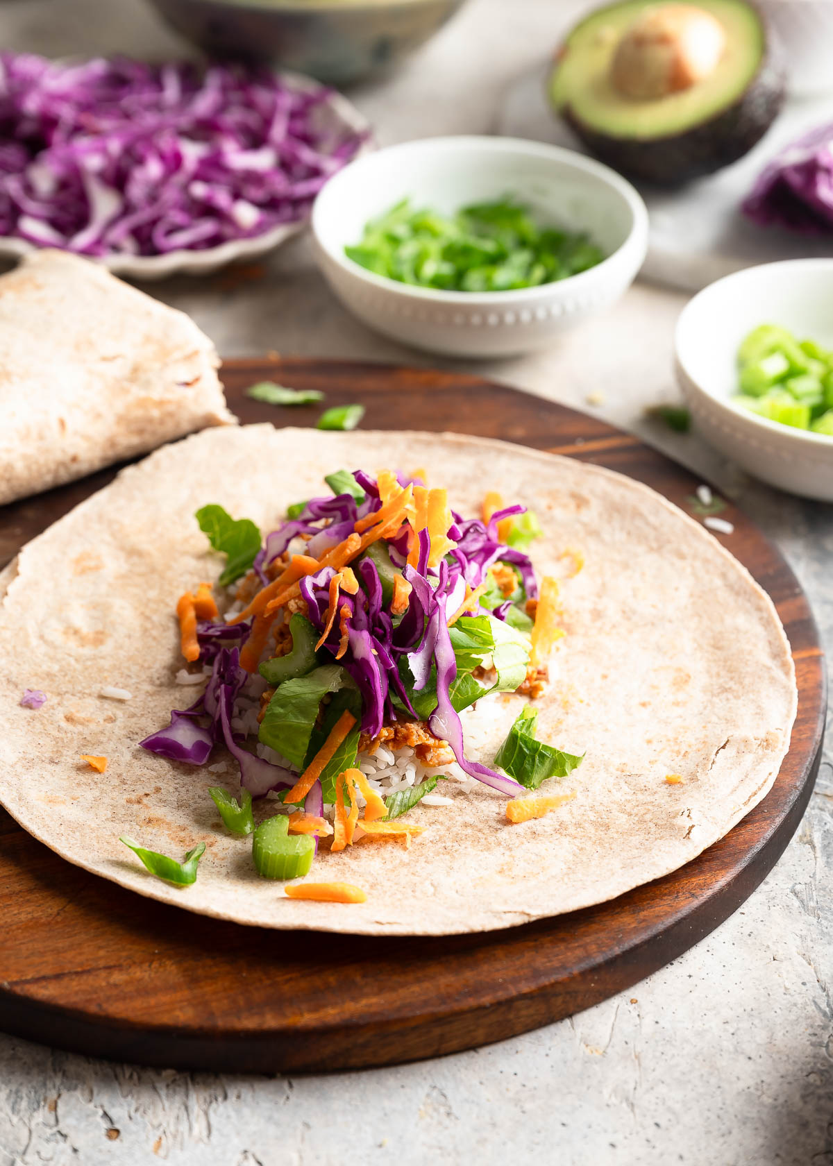 Fresh and colorful vegetables assembled on a tortilla wrap.