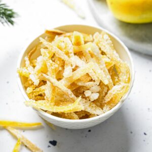 White bowl containing sugared candied lemon peels.
