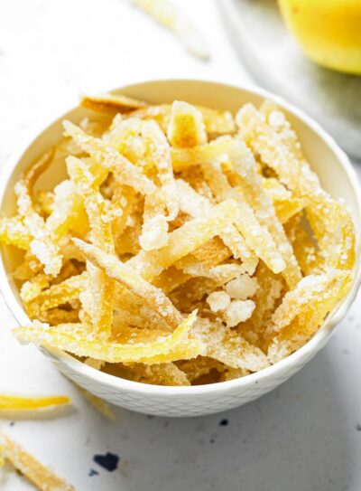 White bowl containing sugared candied lemon peels.