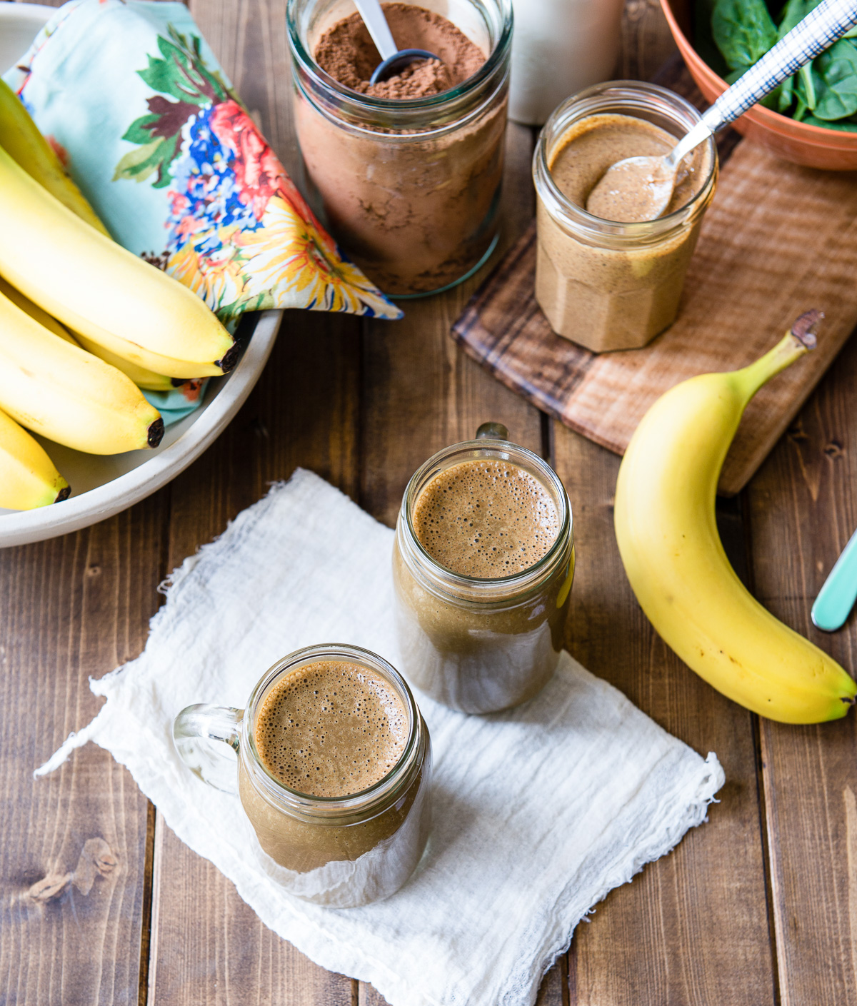 Two glass of chocolate banana smoothie set on a table.