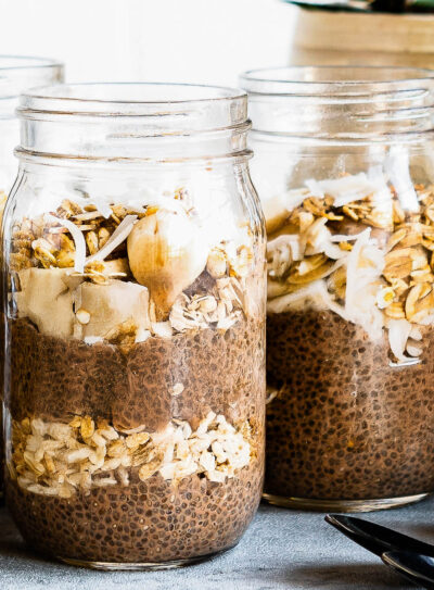 3 jars of chocolate chia pudding layered with fresh fruit and granola.