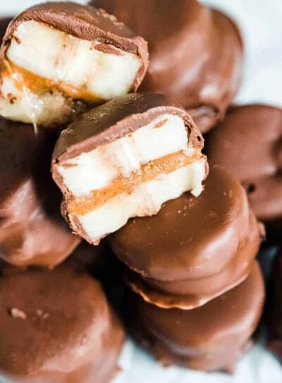 chocolate covered banana bites stacked on plate.