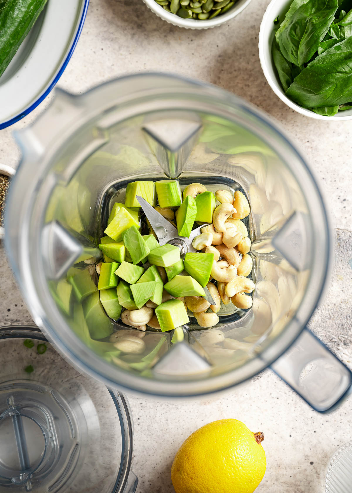A blender containing diced vegetables and cashew.