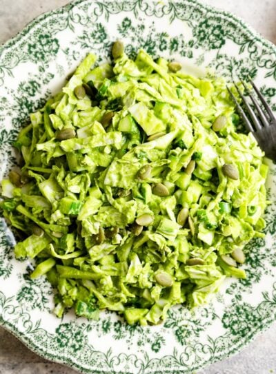 Green goddess salad on a decorative floral plate.