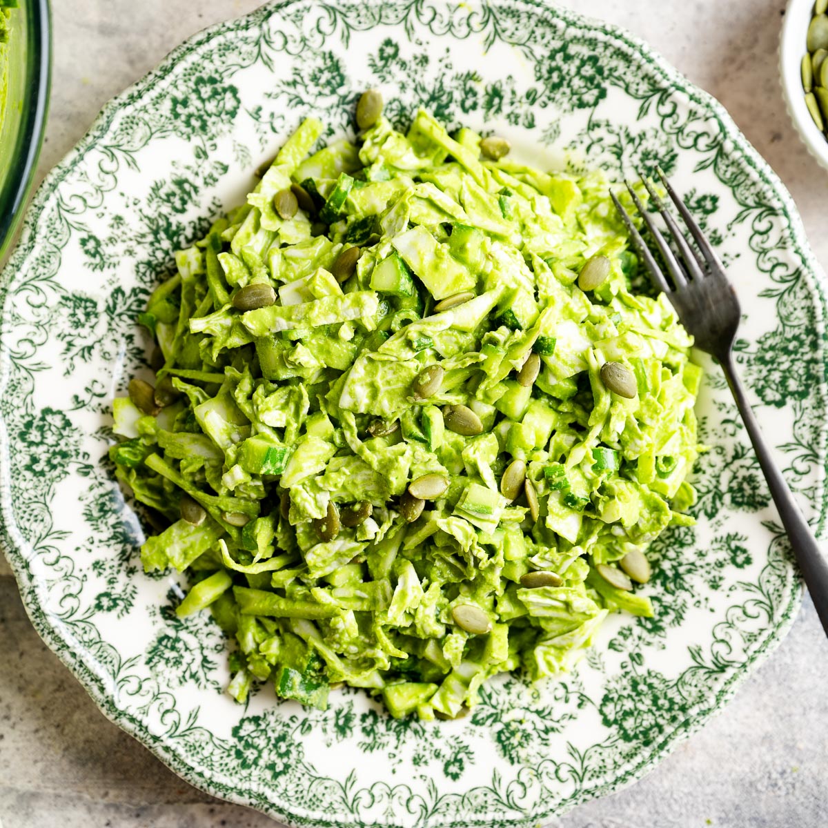 Green goddess salad on a decorative floral plate.