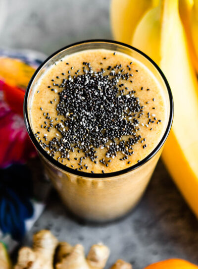 Hangover smoothie in a tall glass topped with chia seeds.