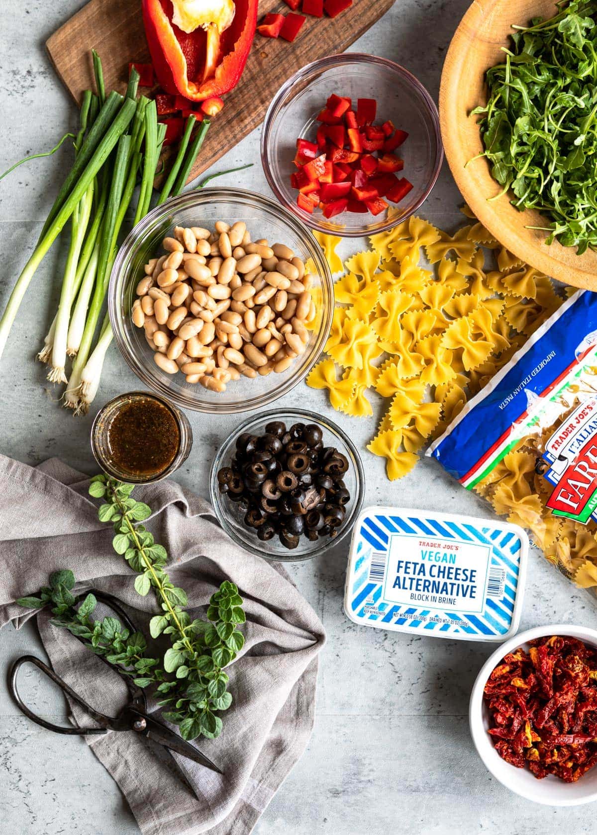 Ingredients to make healthy pasta salad on kitchen counter.