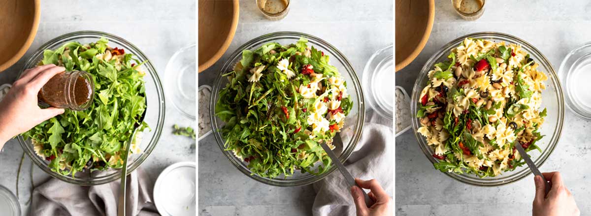 pouring homemade dressing over healthy pasta salad, then tossing the salad to incorporate.