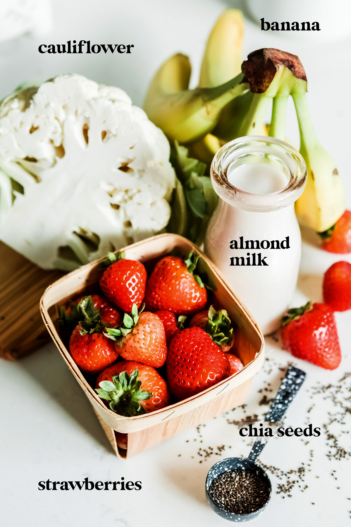 Ingredients to make strawberry banana smoothie recipe in blender.