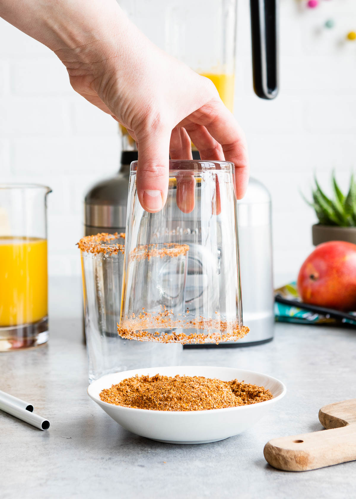 Pulling glass out of a bowl of Tajín seasoning.