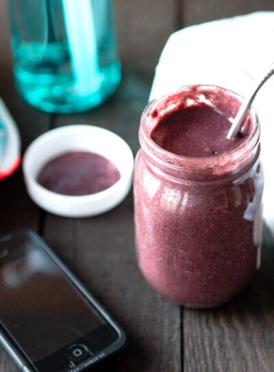 post workout smoothie with water bottle and running shoes.