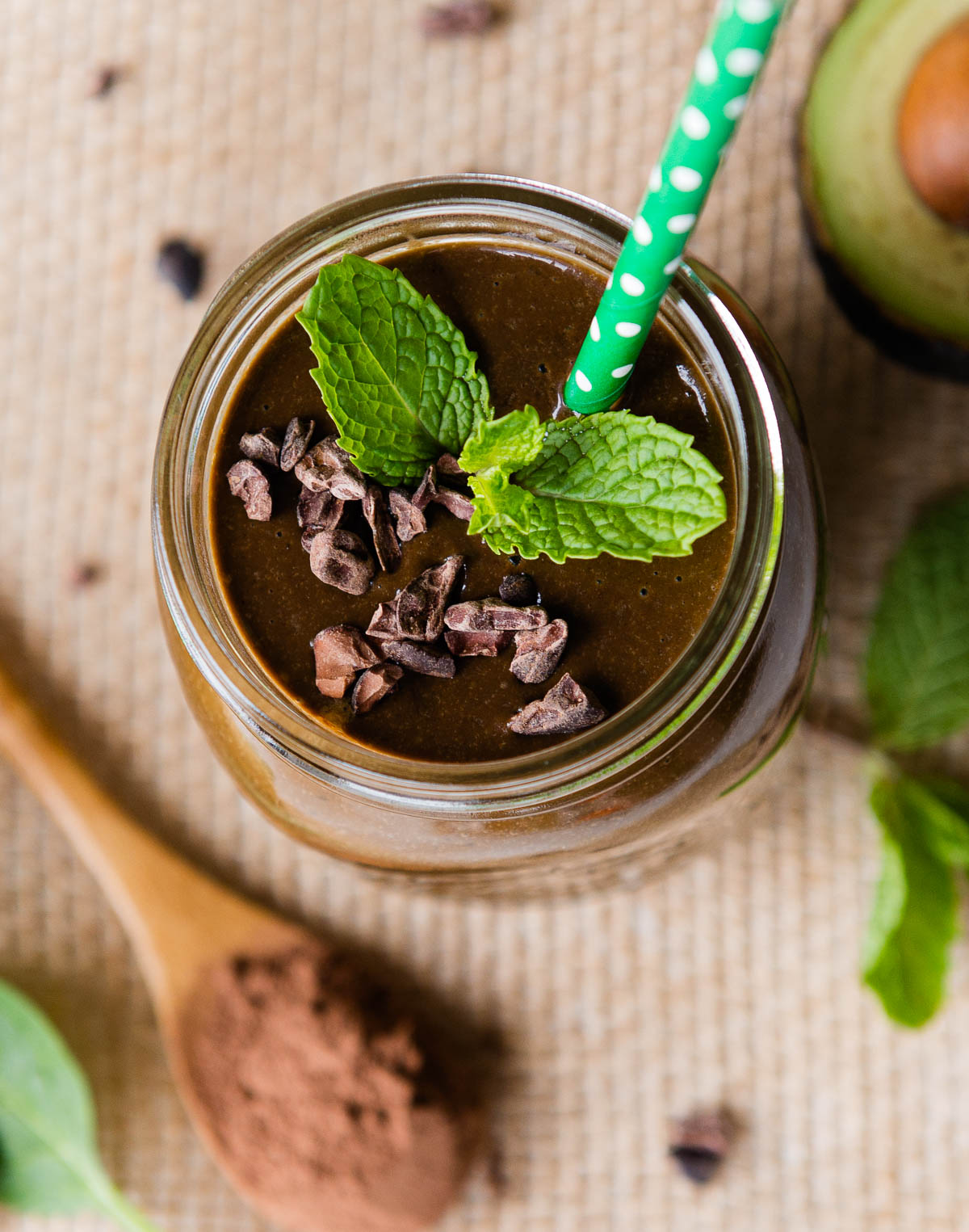 A skinny mint chocolate chip smoothie in a mason jar ready to drink. 