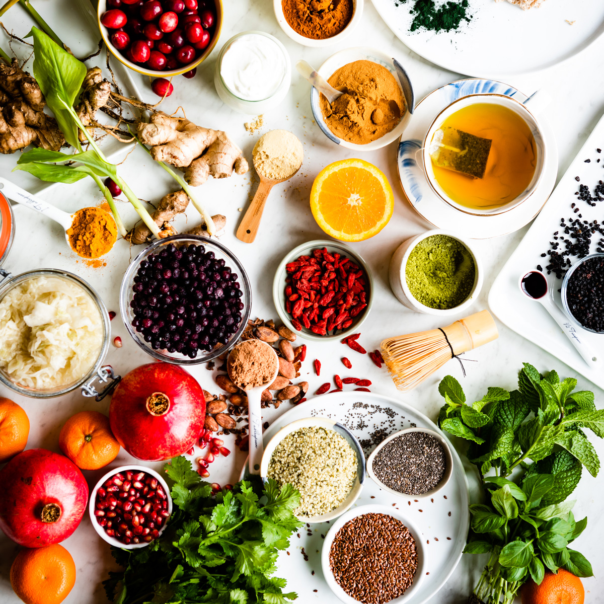 white counter full of bowls of different superfoods.