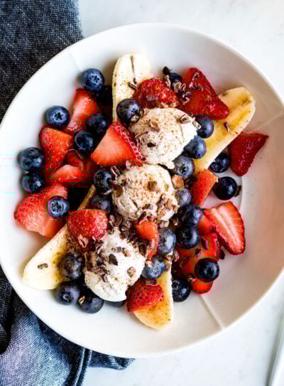 Vegan banana split on a plate with fresh berries