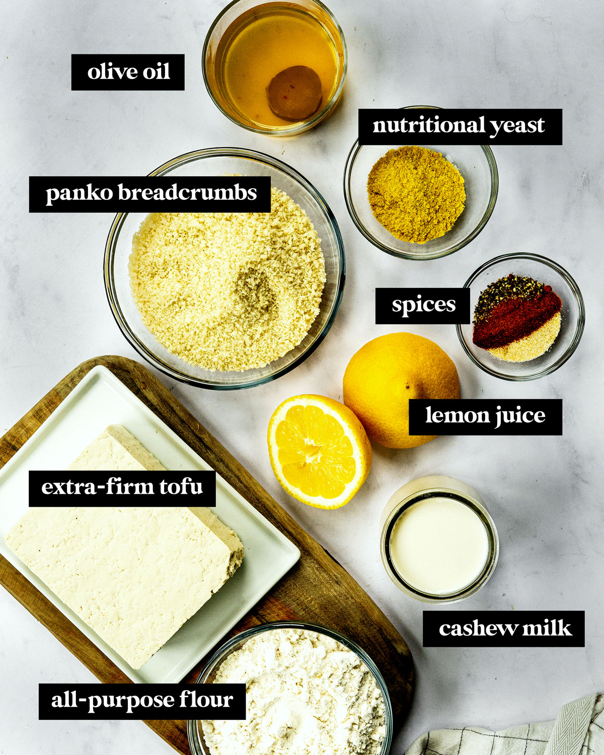 Ingredients to make vegan chicken nuggets on counter include tofu, breadcrumbs and lemon juice.