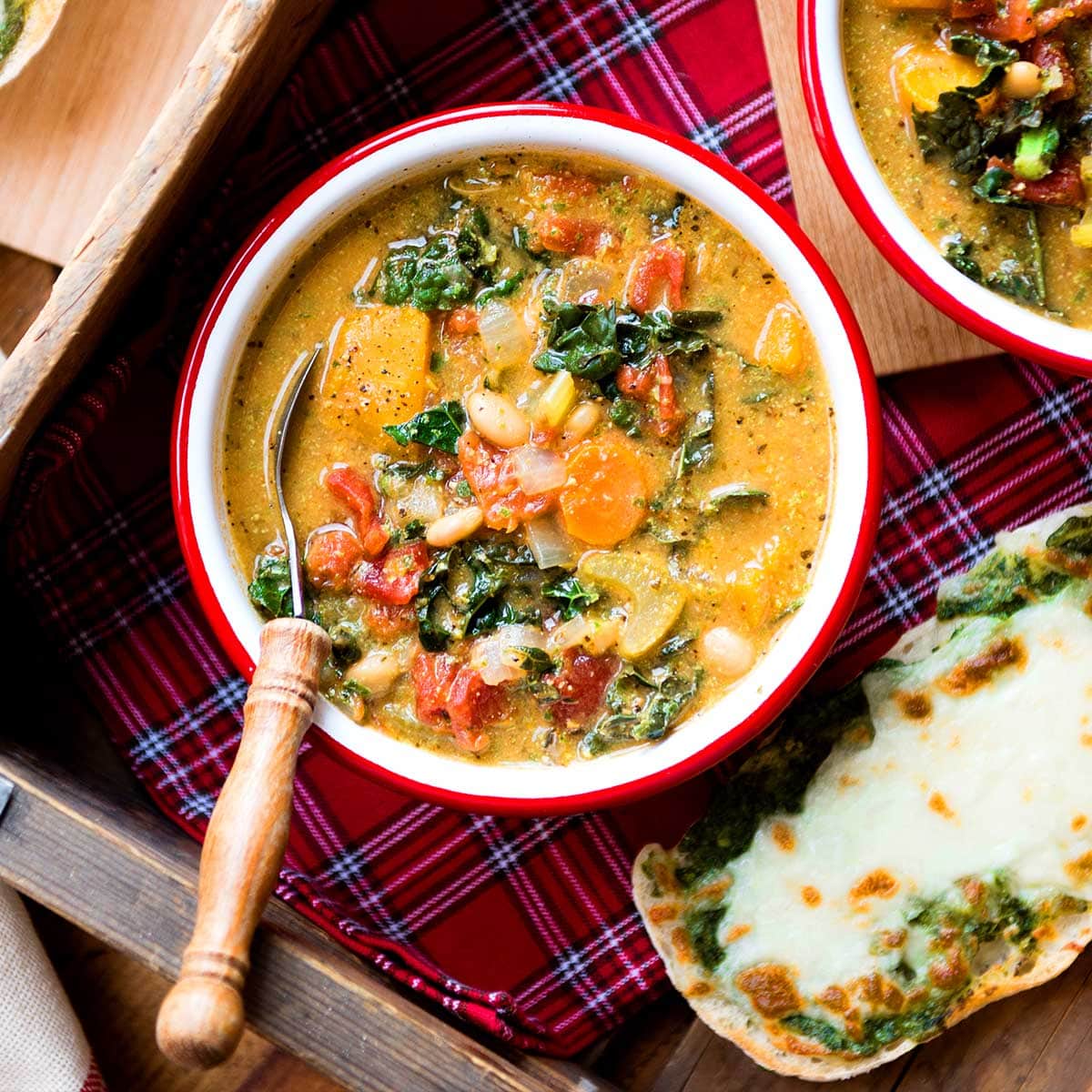 Vibrant, loaded vegan minestrone soup in a bowl.