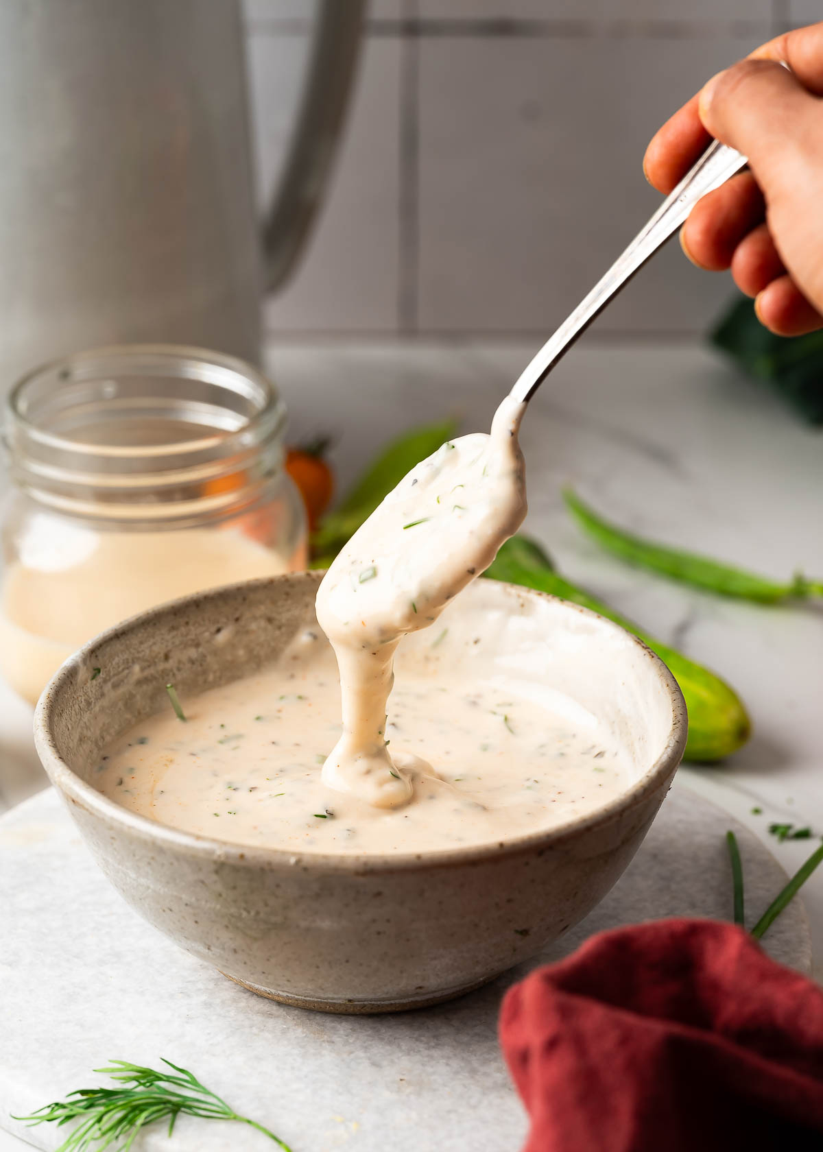 Mixing ranch ingredients with a spoon.