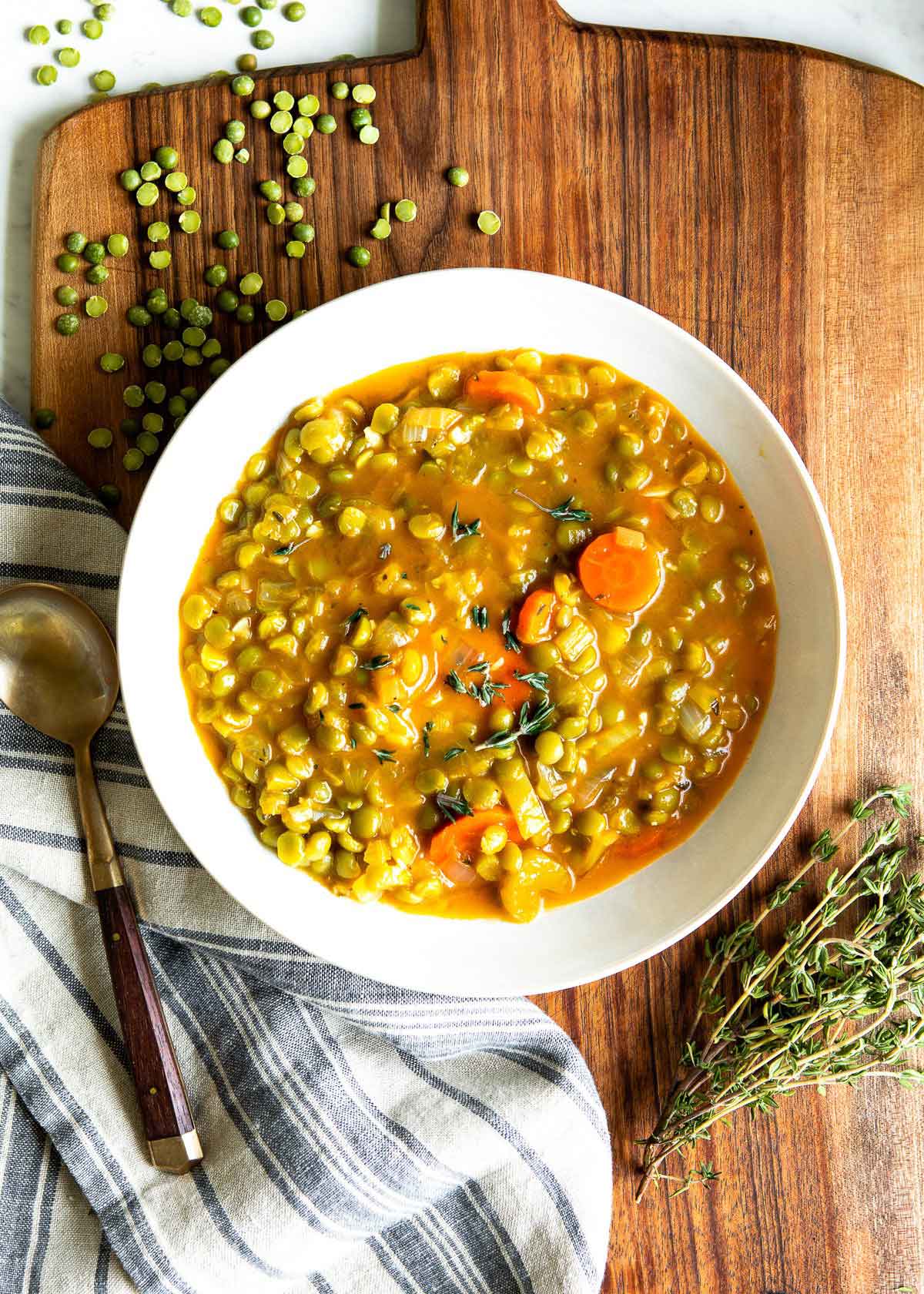 Cooked vegetarian split pea soup recipe in a white stock pot, ready to serve.