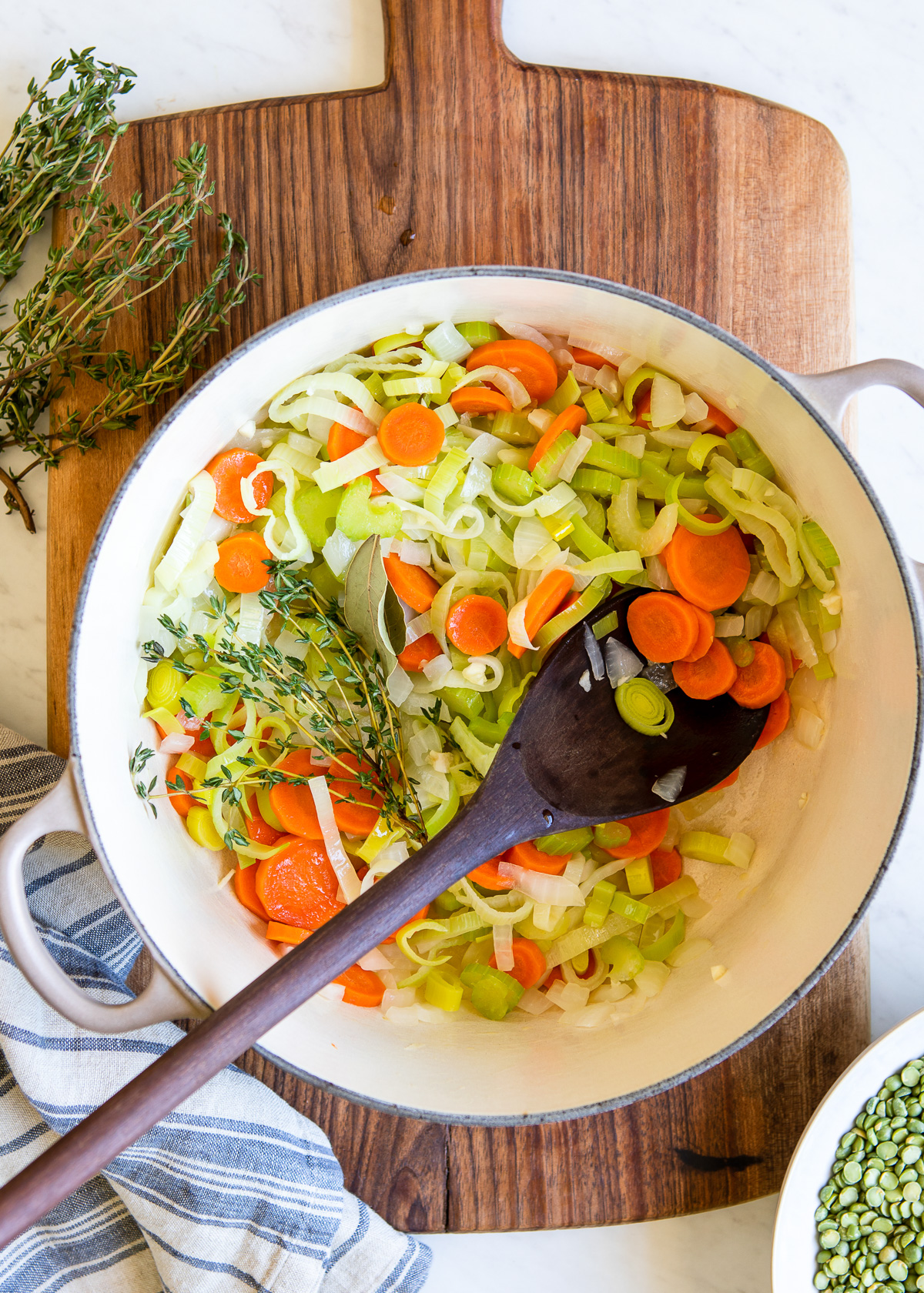 White stock pot with onions, carrots, celery and leeks.